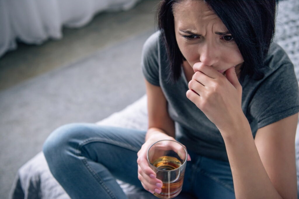 a woman crying with a glass in her hand