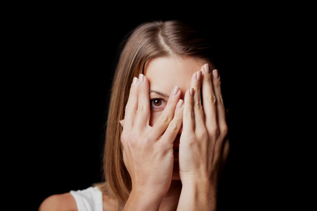 A woman covering her face with hands