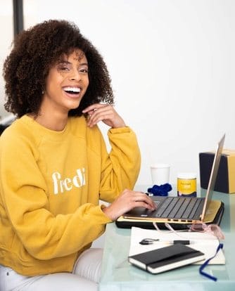 young woman in yellow laughing