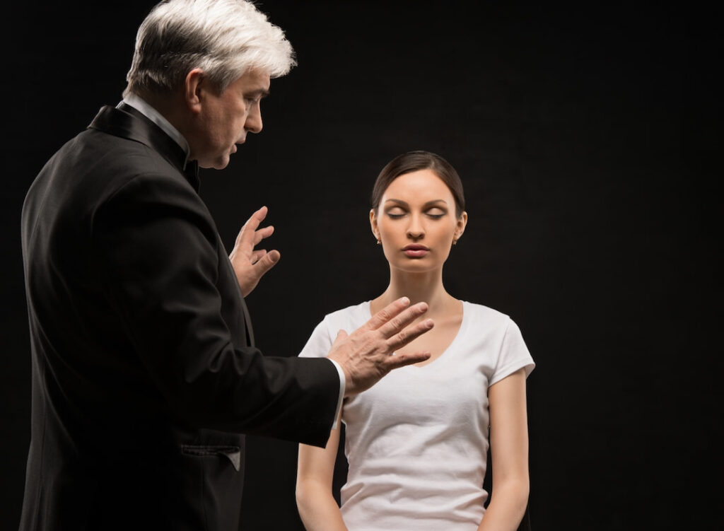 A man hypnotizing a woman