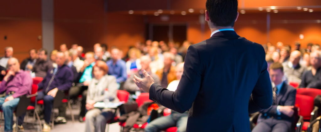 a man speaking to the audience