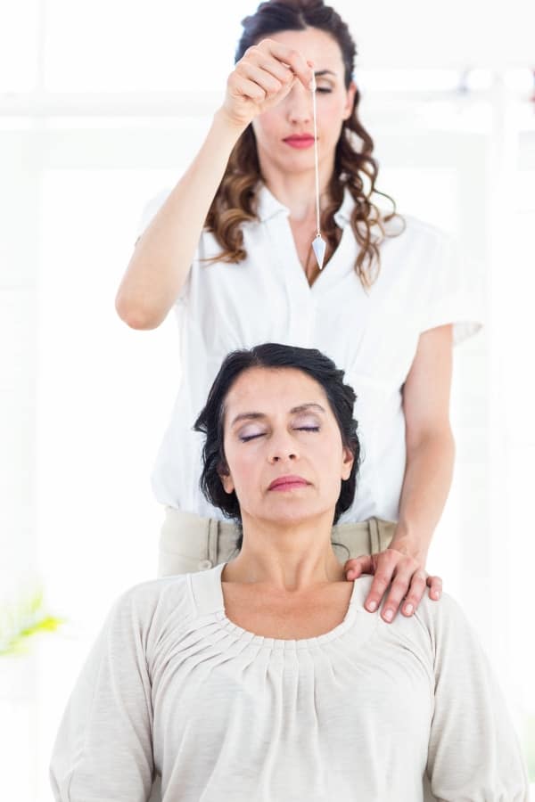 A therapist hypnotizing her patient