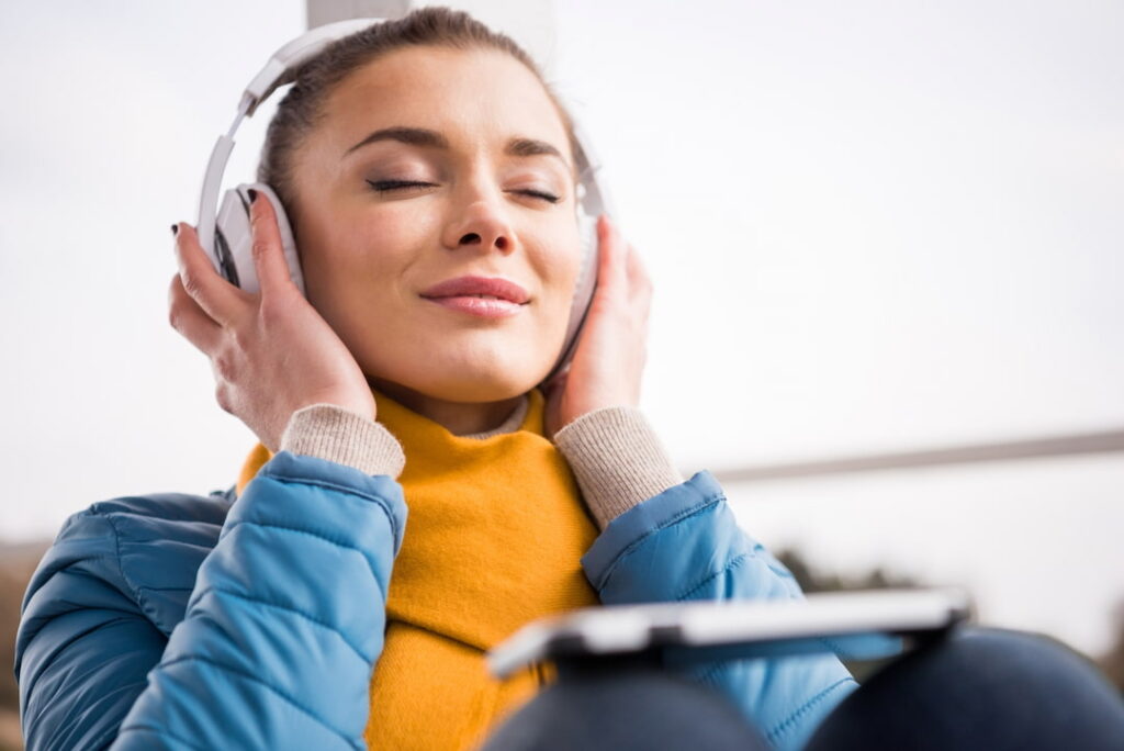 a beautiful girl with headphones and closed eyes