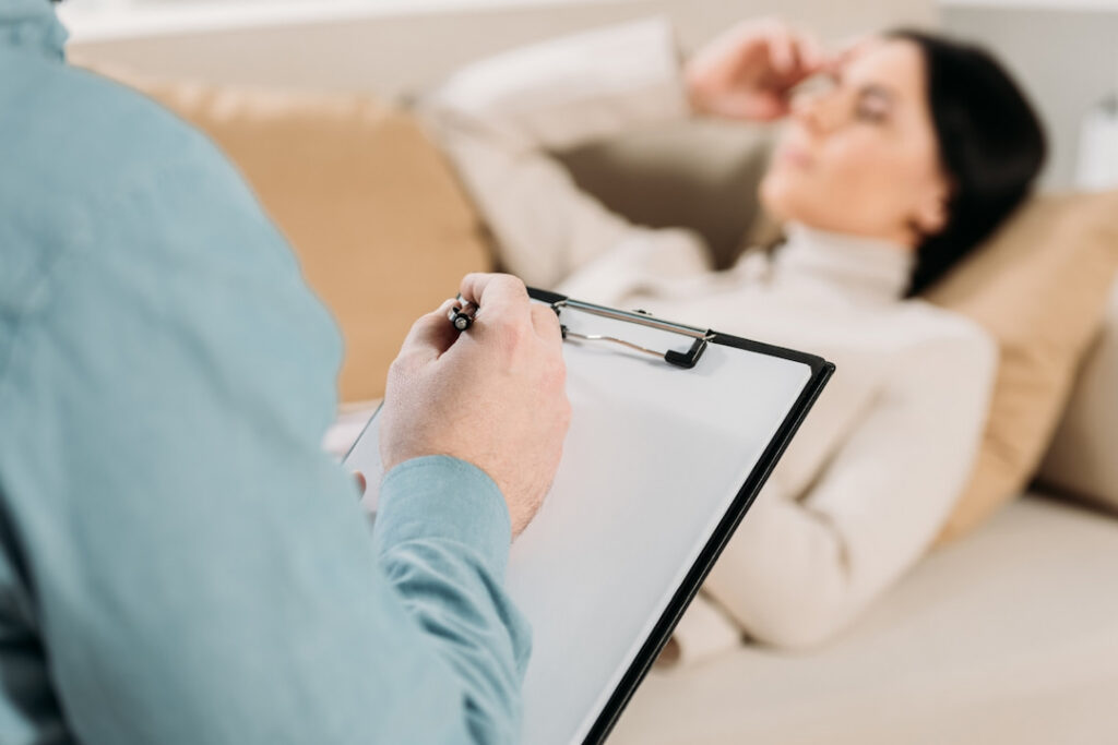 a therapist holding a clipboard with notes