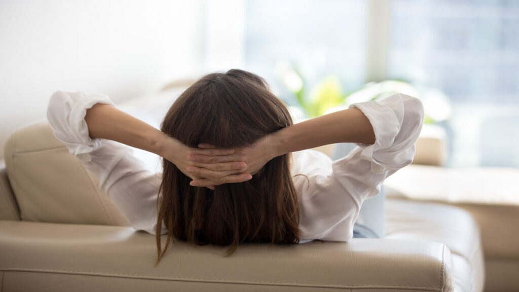 a woman relaxing on a cozy sofa