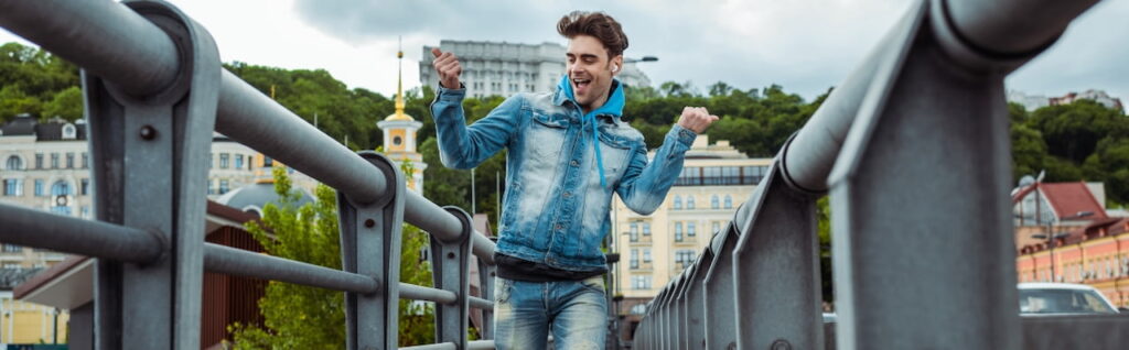 a happy young man on the bridge