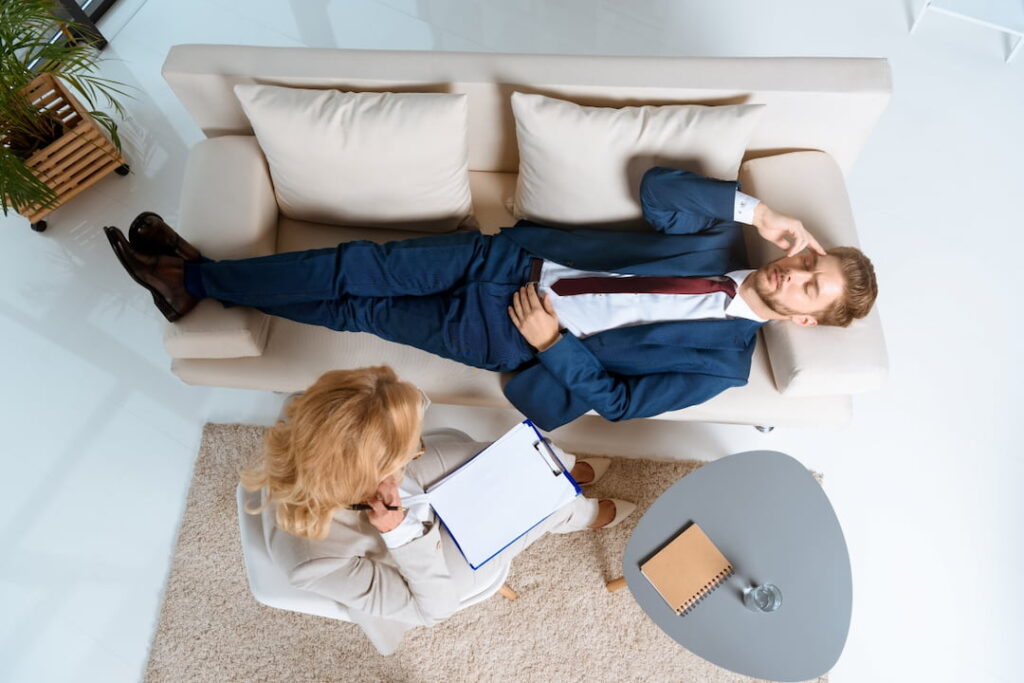 a man lying down on the couch during the hypnotherapy session