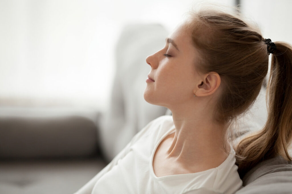 a young girl taking a deep breath