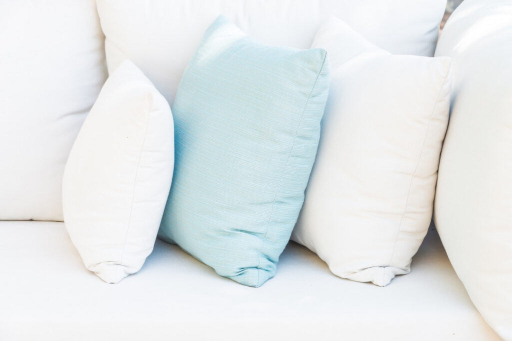 white and light blue pillows on the sofa