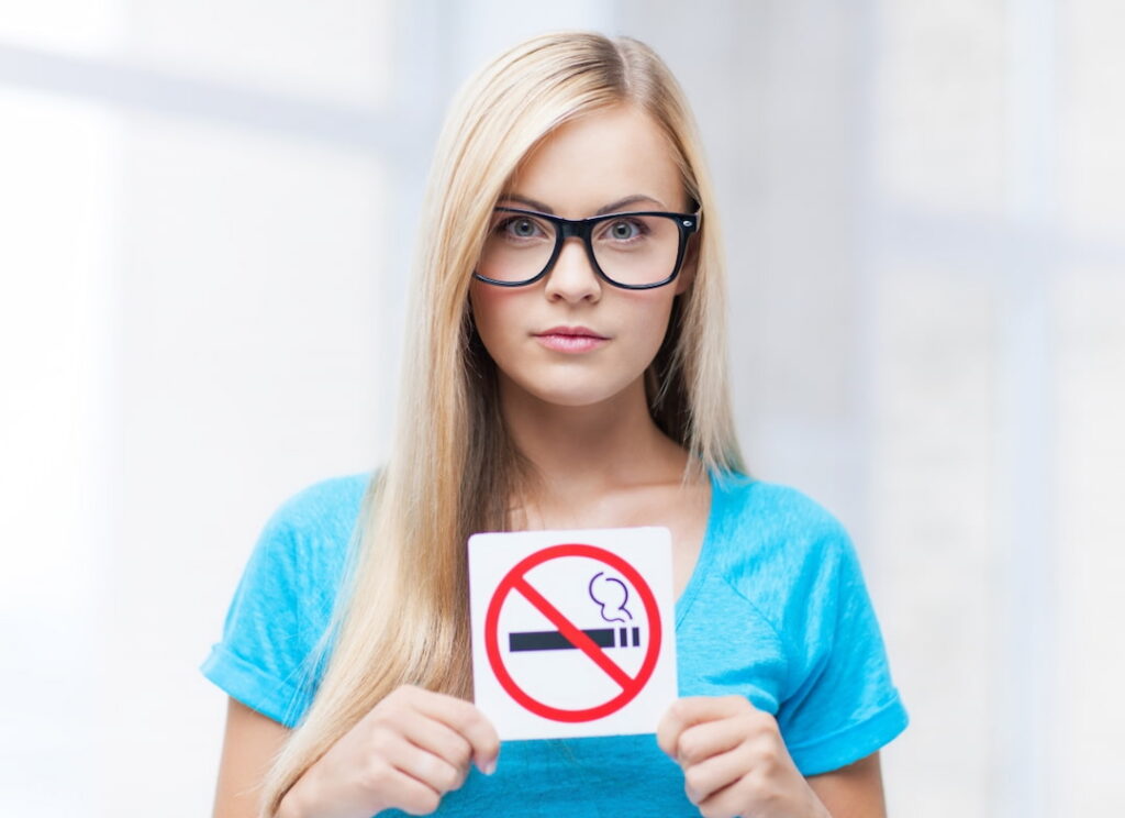 A woman holding smoking restriction sign