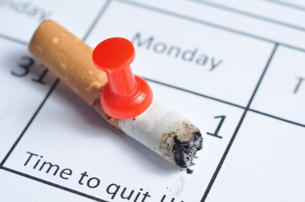 a cigarette pinned to the calendar