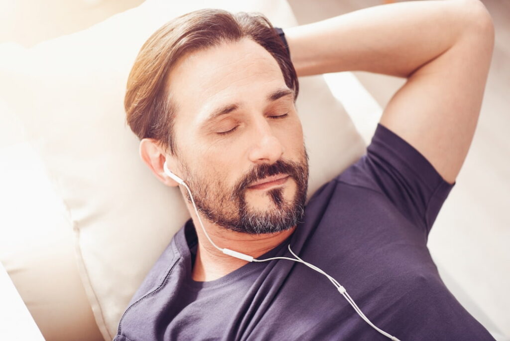 a man listening to hypnosis audio