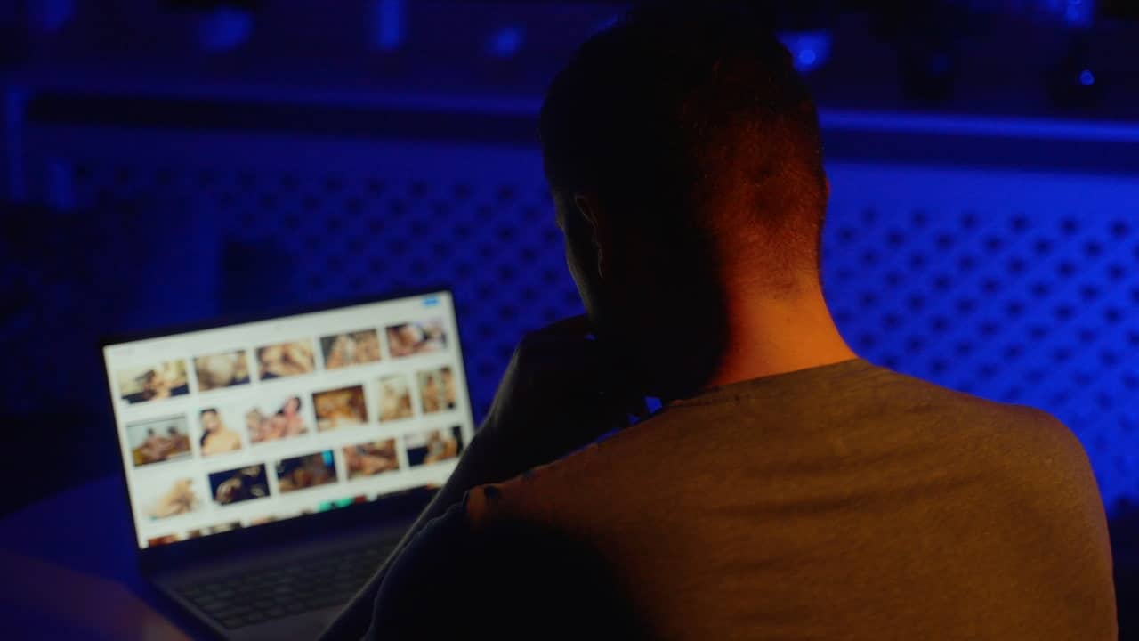 Man browsing porn site late at night