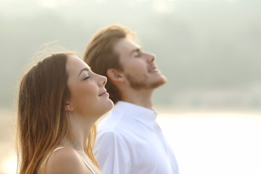 a man and a woman relaxing outside