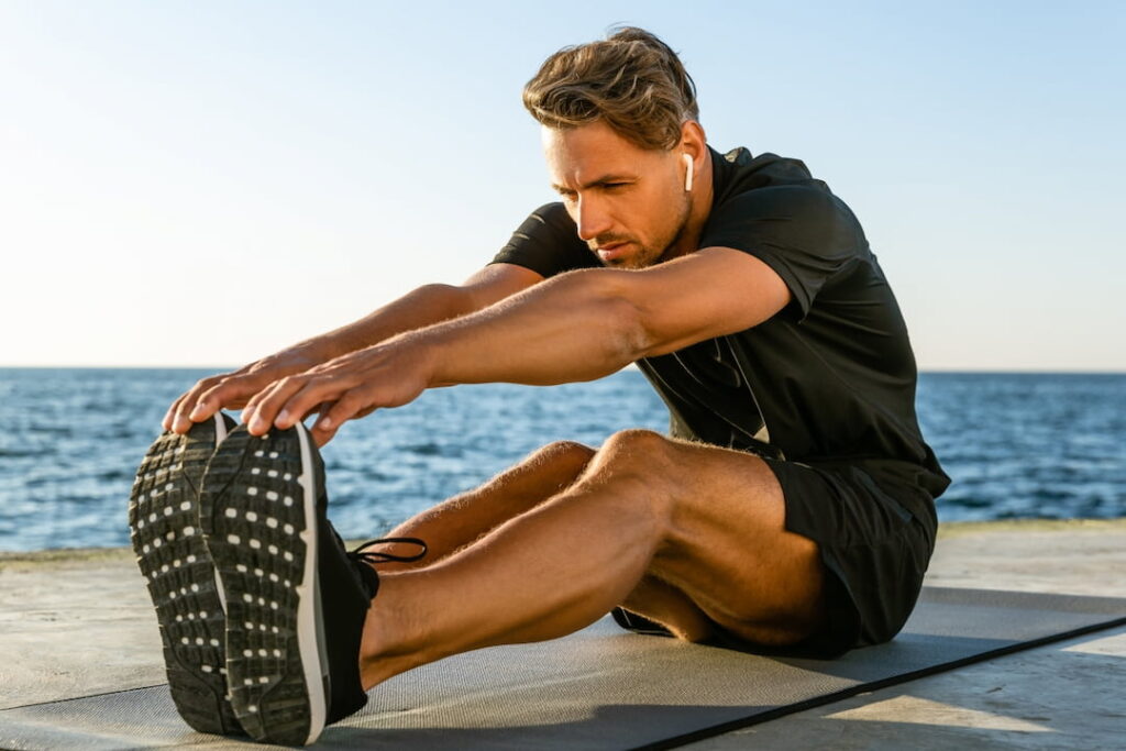 a man working out by the sea