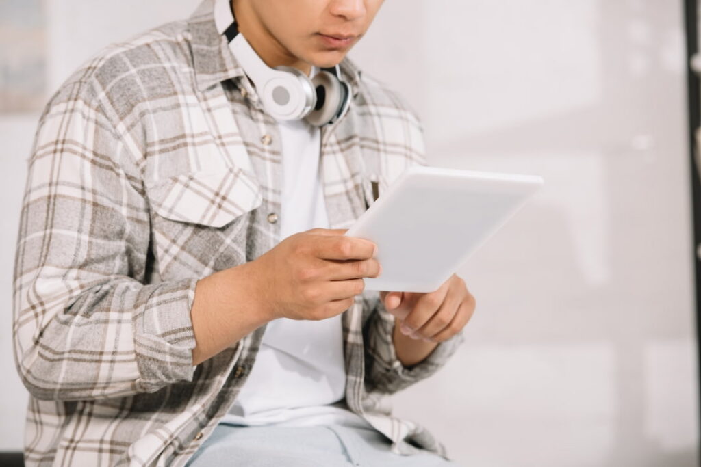 young man with tablet and headphones