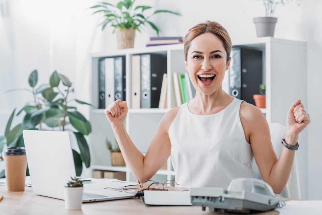 a woman celebrating success at workplace