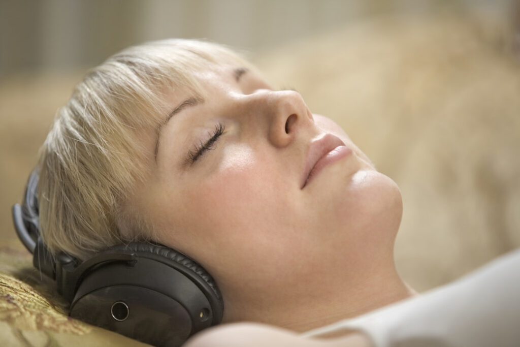 a woman listening to hypnosis session