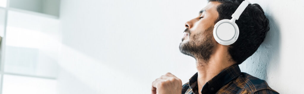 young man with headphones and closed eyes