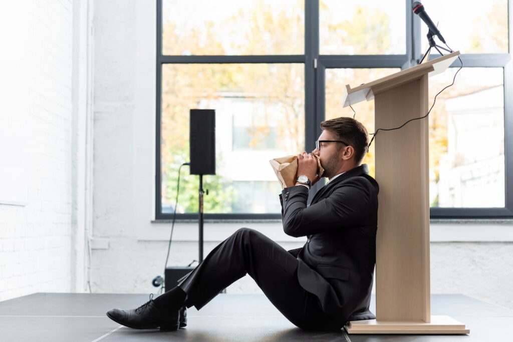 a man breathing into the paper bag