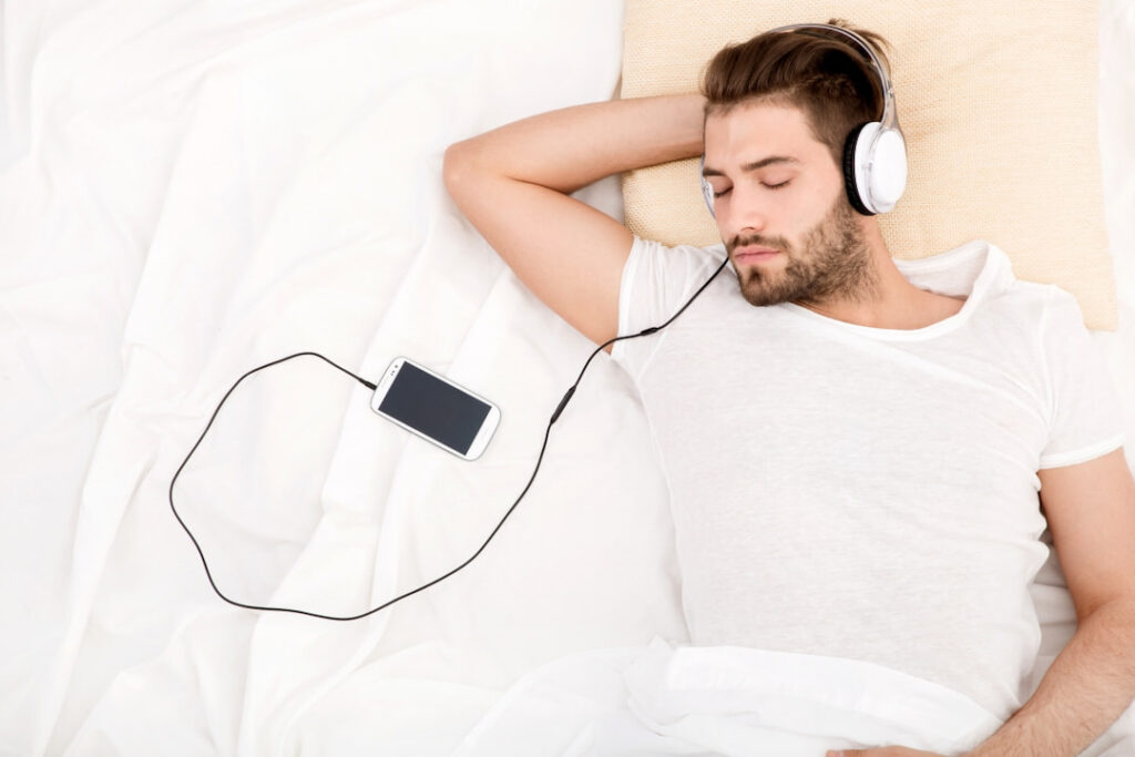 a man listening to audios from his cellphone