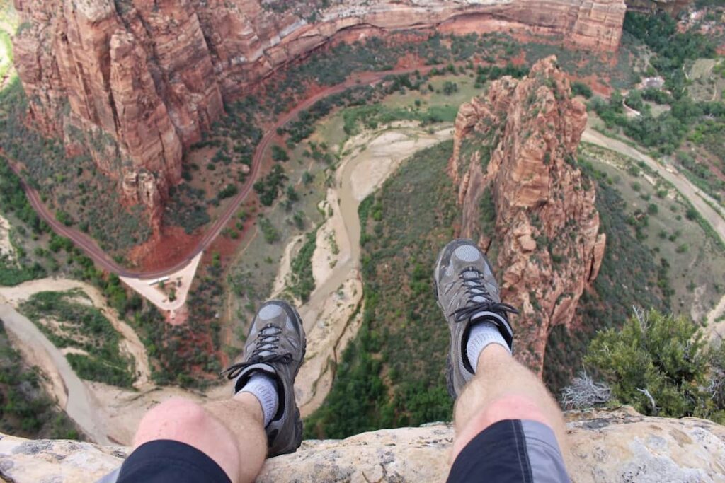 a person sitting on the edge of the mountain