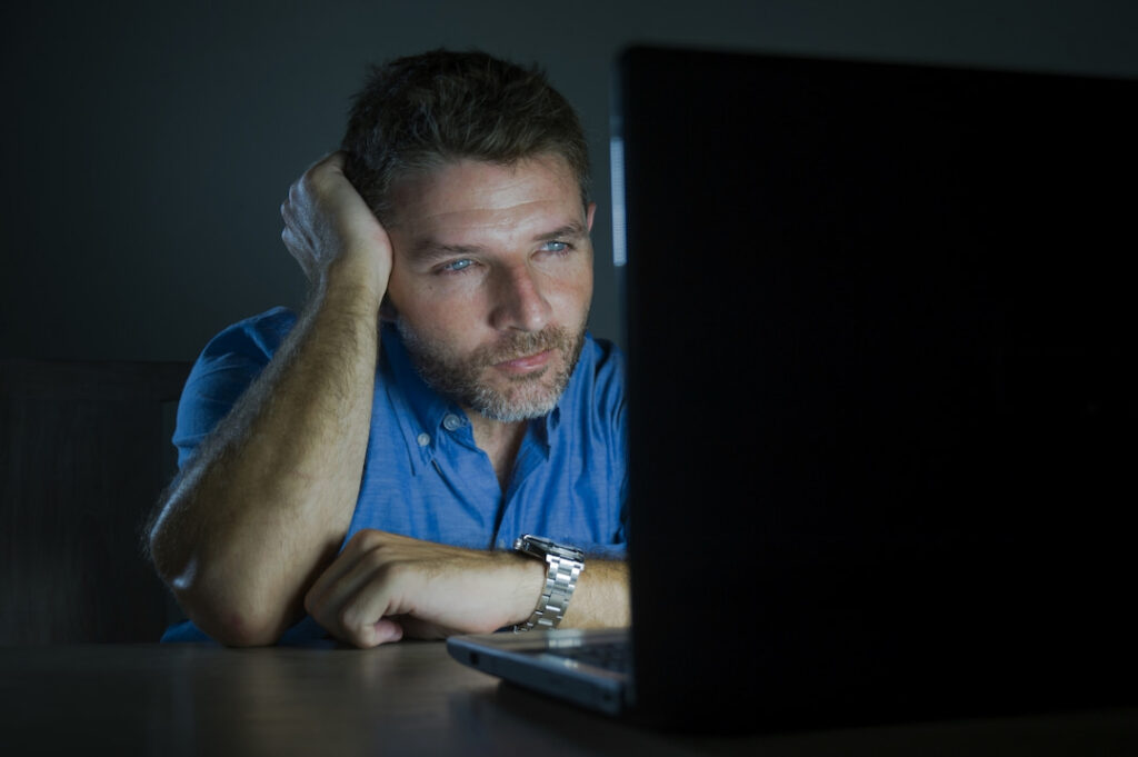 a man watching porn on his laptop