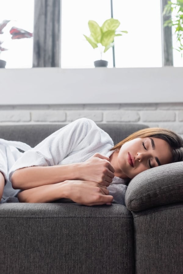 woman lying on the couch with her eyes closed