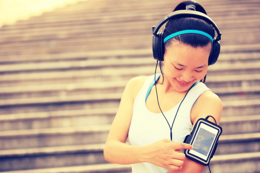 a young girl choosing audio from her playlist on the cellphone