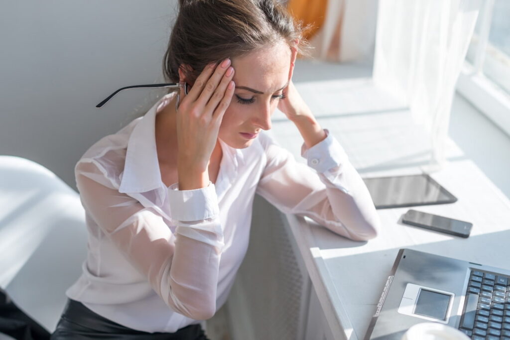 a woman with headache trying to overcome the pain