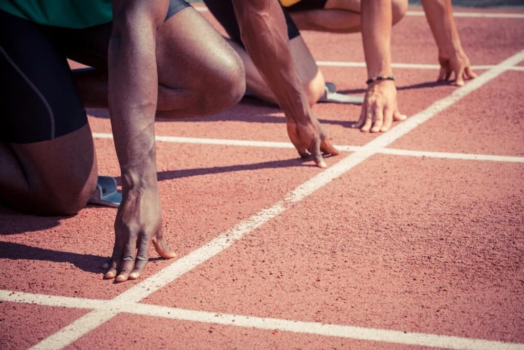 two athletes in the tracks ready for the race start