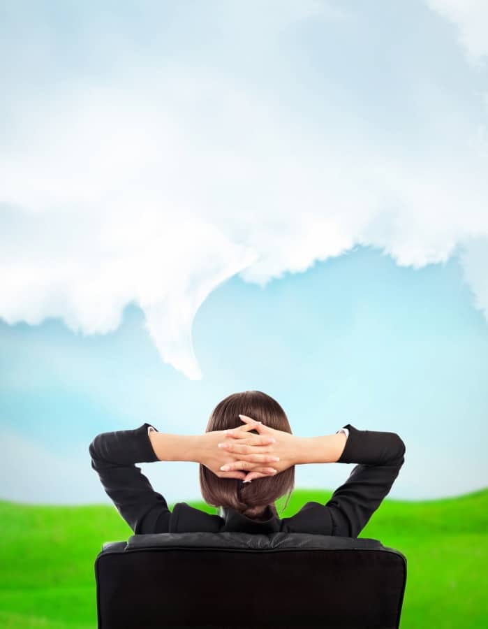 a woman sitting in the chair and looking to the clouds on the sky