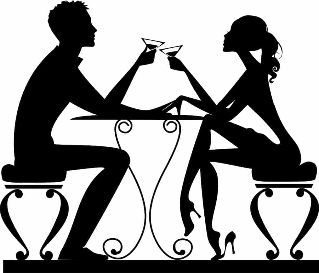 silhouette of a man and a woman at a table with glasses in hands