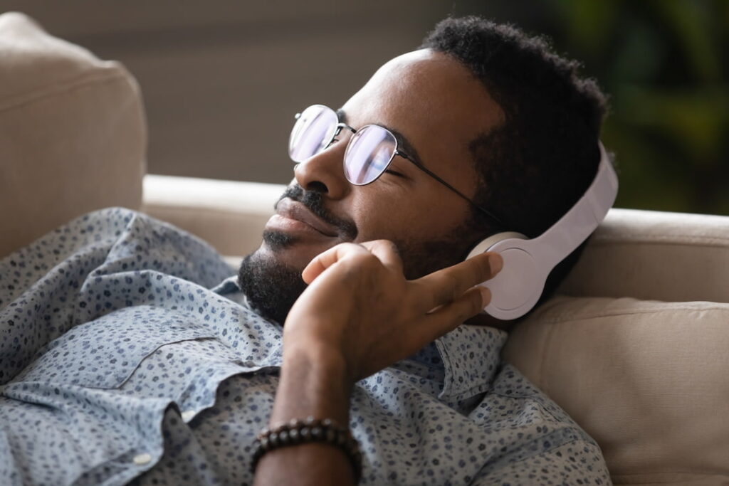 young man listening audios on his headphones