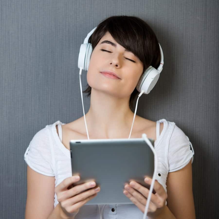 a woman listening to audios on her notebook