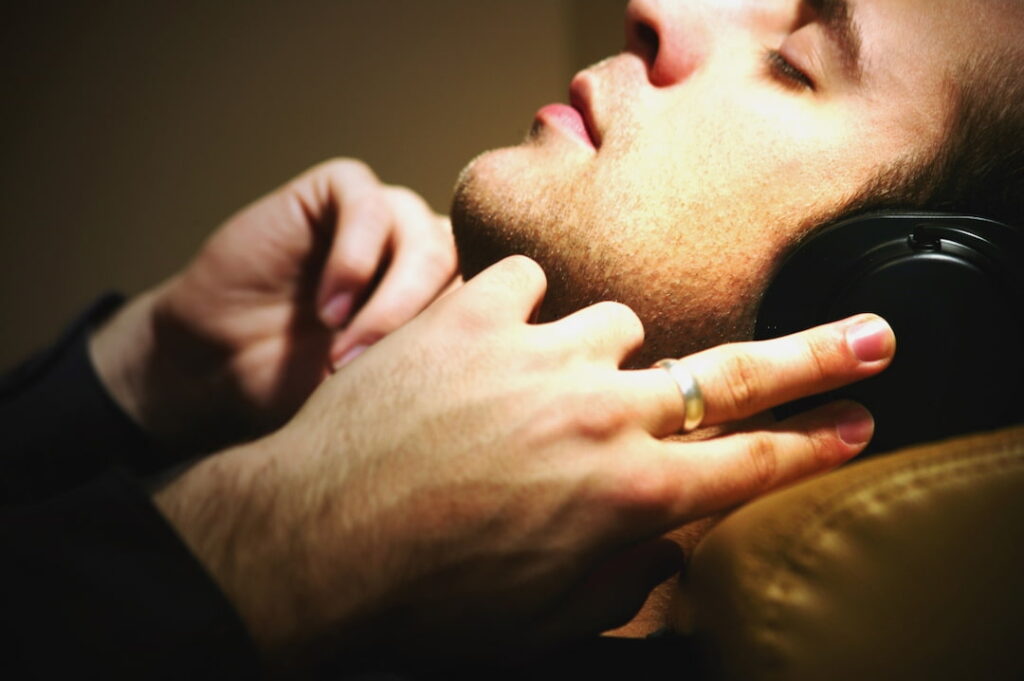 a man with headphones listening to guided hypnosis