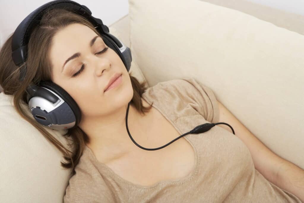 a woman with closed eyes and headphones