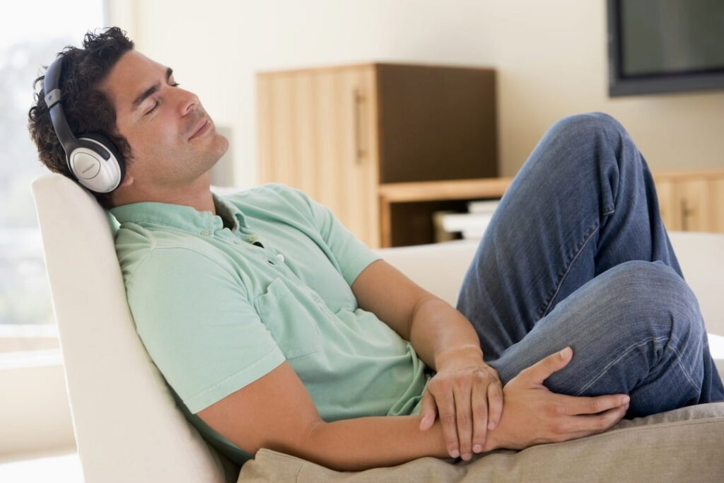 man listening to audios with headphones on his head