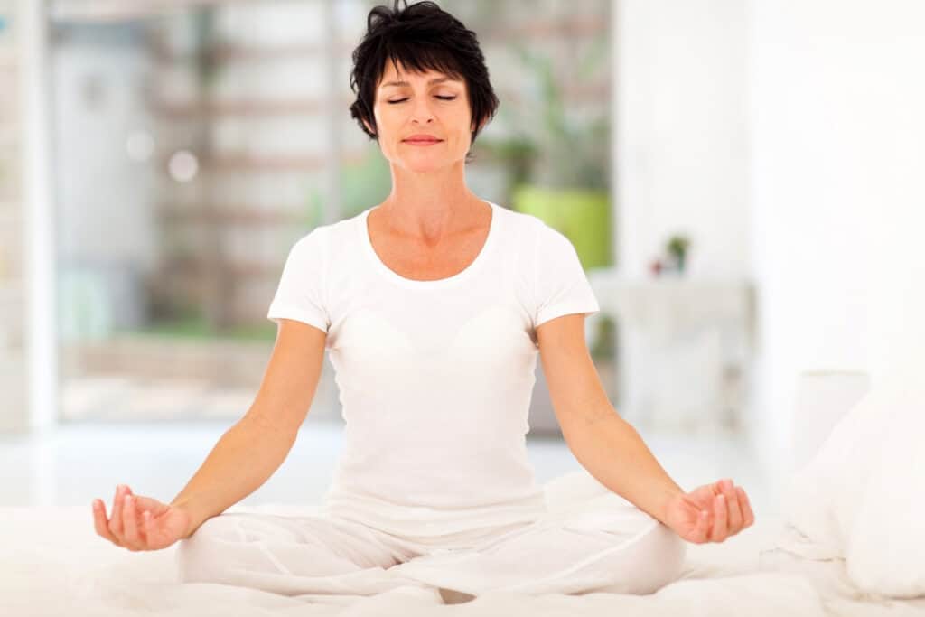 a woman in white meditating