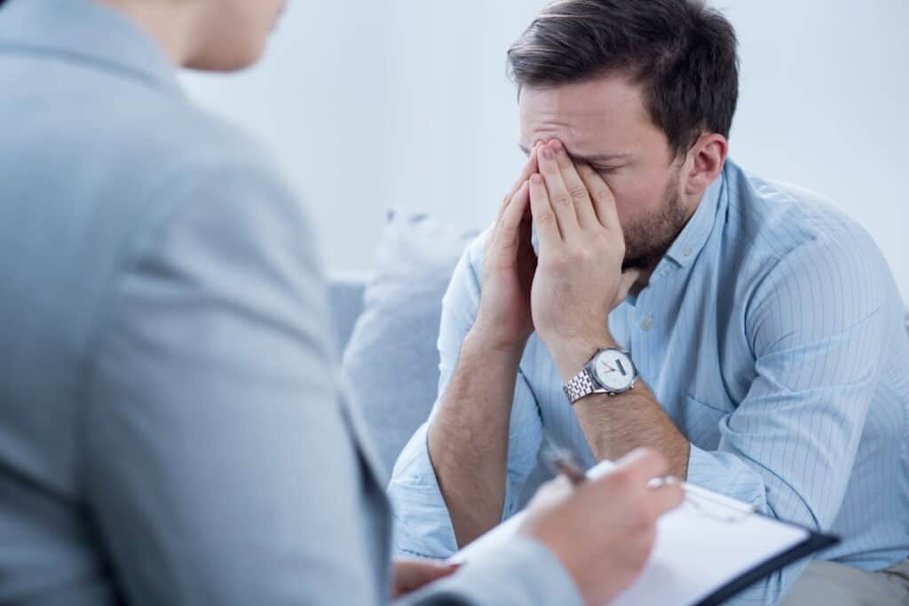 a man at the therapy session with his therapist