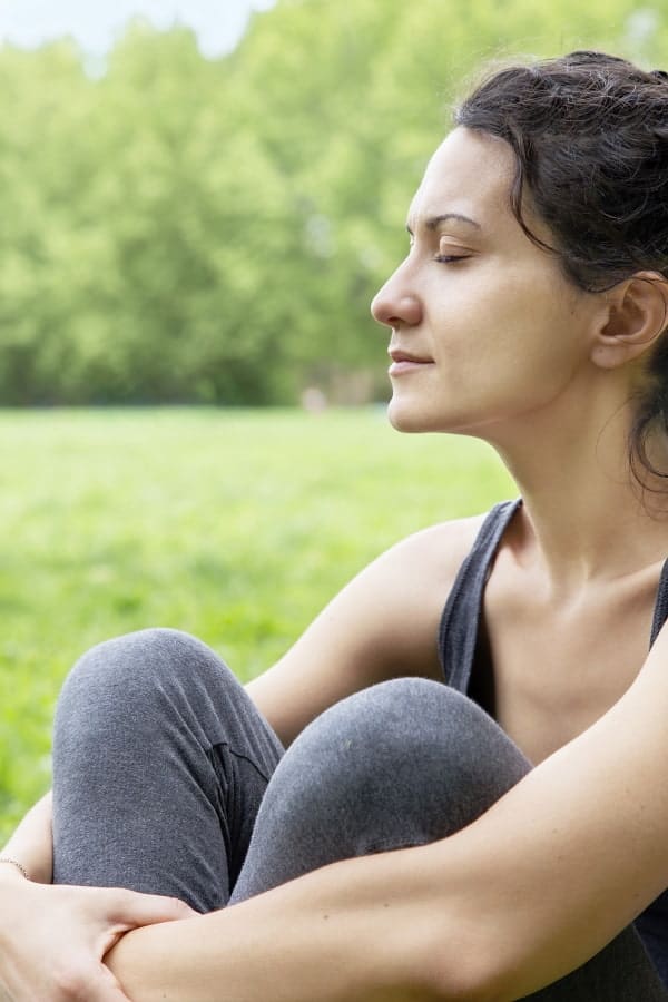 young woman relaxing in a green field