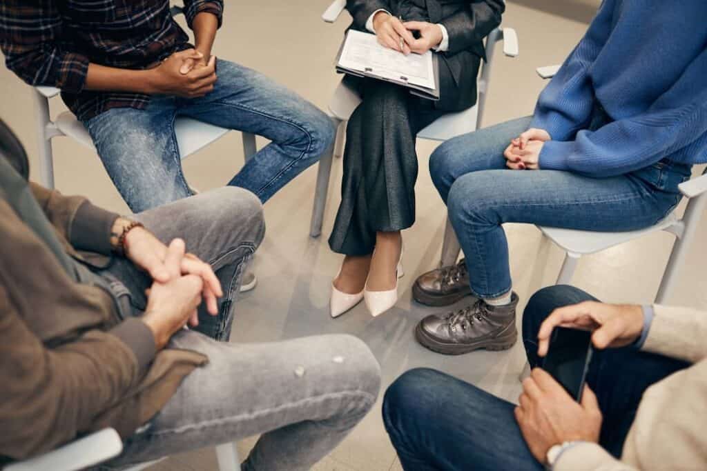 people sitting in a circle on the group therapy