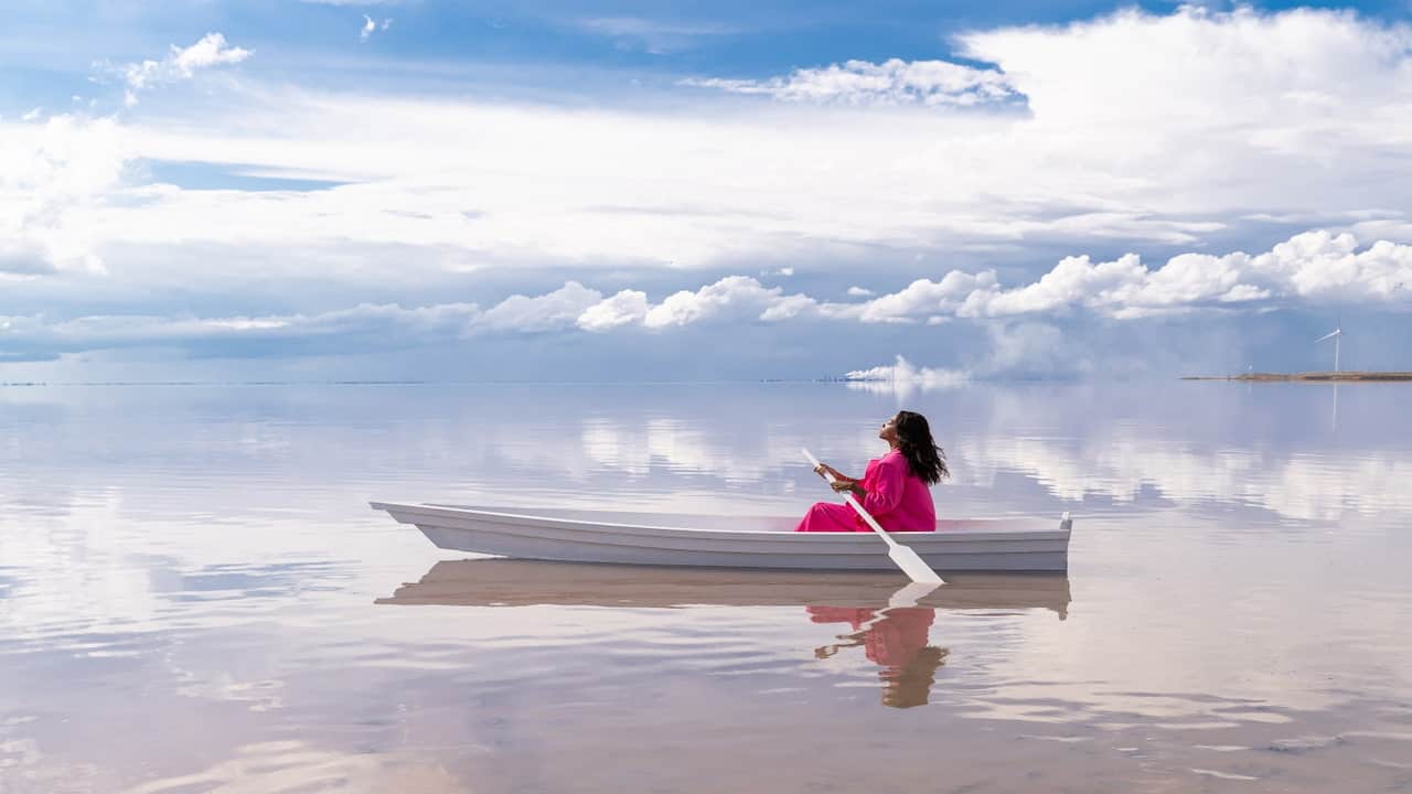 a woman sitting in the boat on the sea