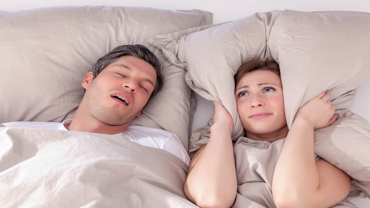 a man snoring beside his wife