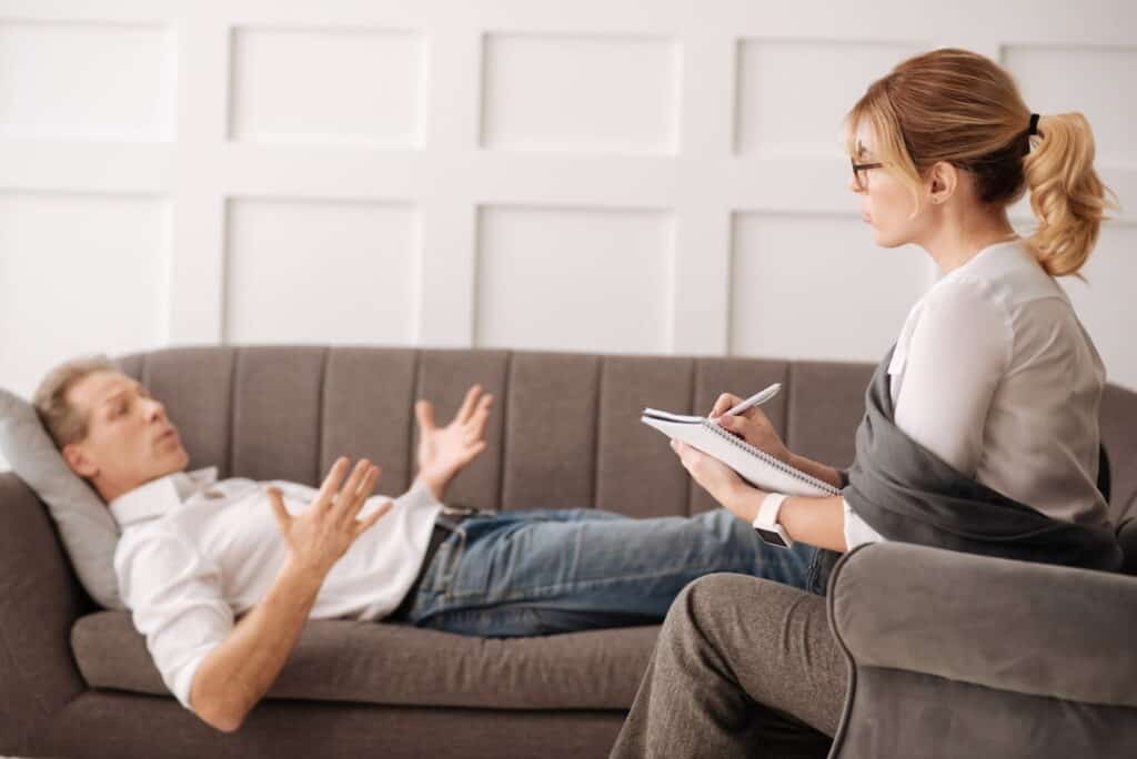 a man lying on the couch during the hypnosis session