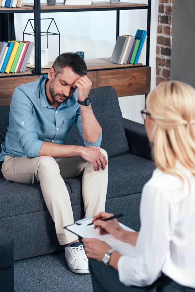 depressed man sitting on the couch during the therapy session