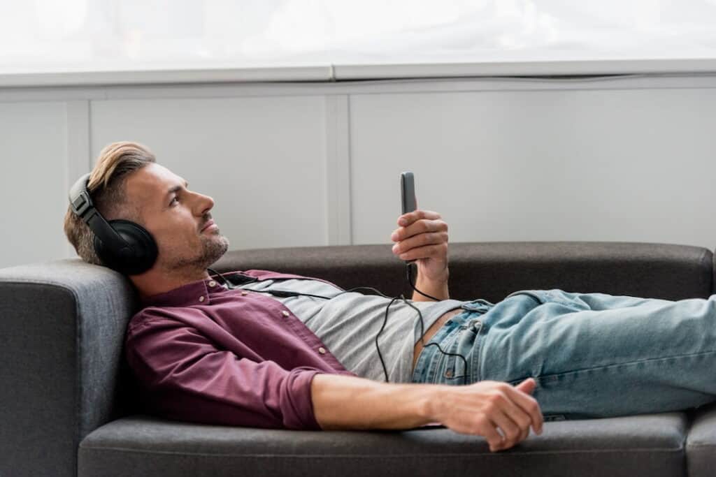 a man with headphones listening to audios 