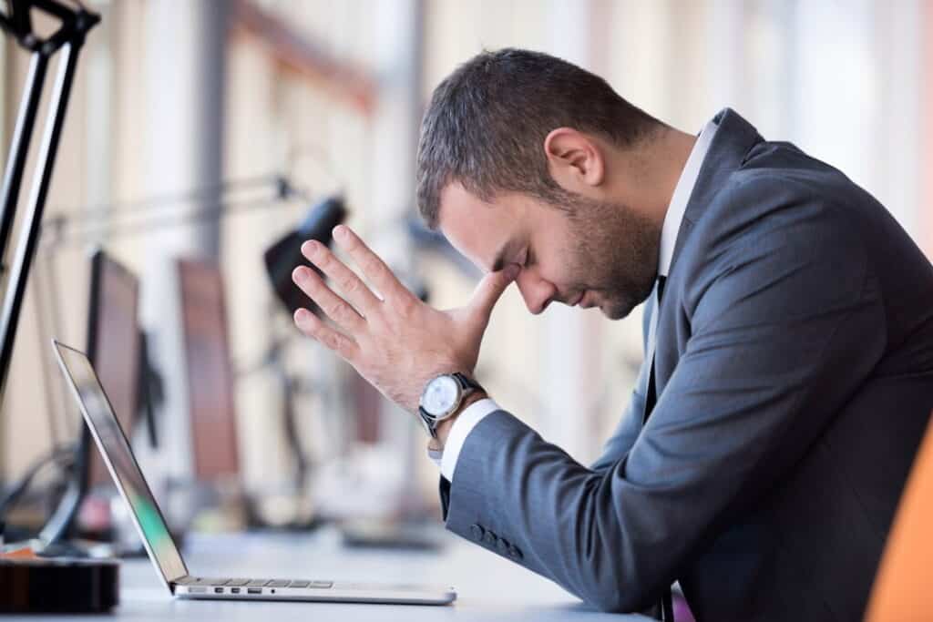 a man focusing while sitting at the table