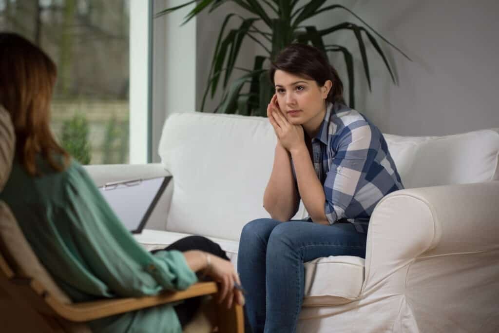 a woman with her therapist at the hypnosis session