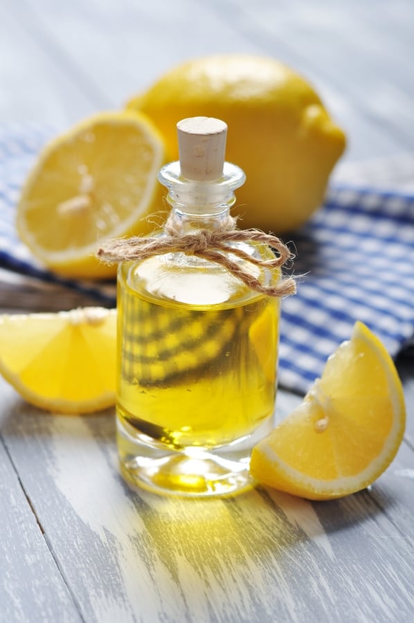 a bottle of oil and slices of lemon